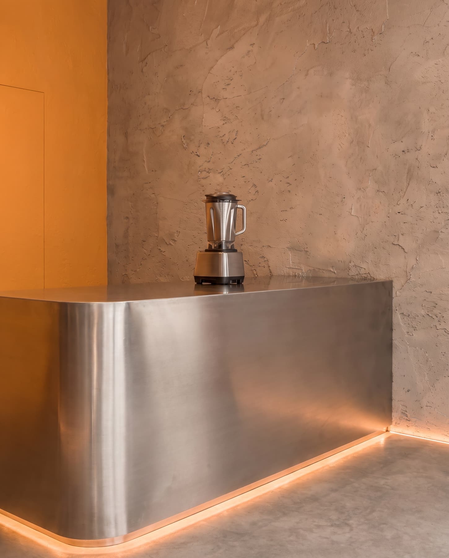 A steel blender on the brushed steel counter
